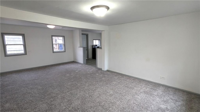 unfurnished room featuring baseboards and carpet floors