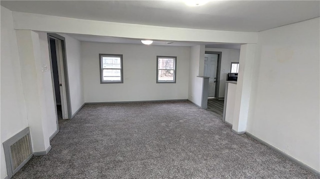 spare room with visible vents, baseboards, and carpet