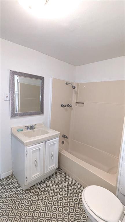 bathroom featuring vanity, shower / bathing tub combination, and toilet