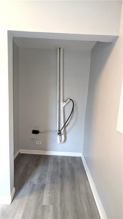 laundry room featuring wood finished floors and baseboards