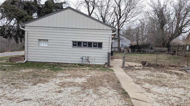 view of home's exterior with fence