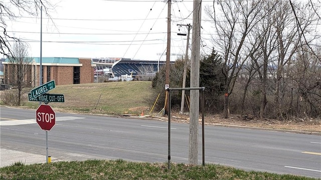 view of road featuring curbs and traffic signs