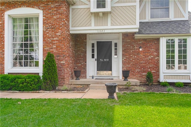 11643 Glen Arbor Ter, Kansas City, MO 64114 - property entrance with brick siding, a yard, and a shingled roof
