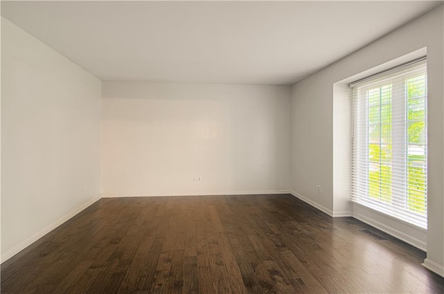 11643 Glen Arbor Ter, Kansas City, MO 64114 - empty room featuring dark wood-style flooring and baseboards
