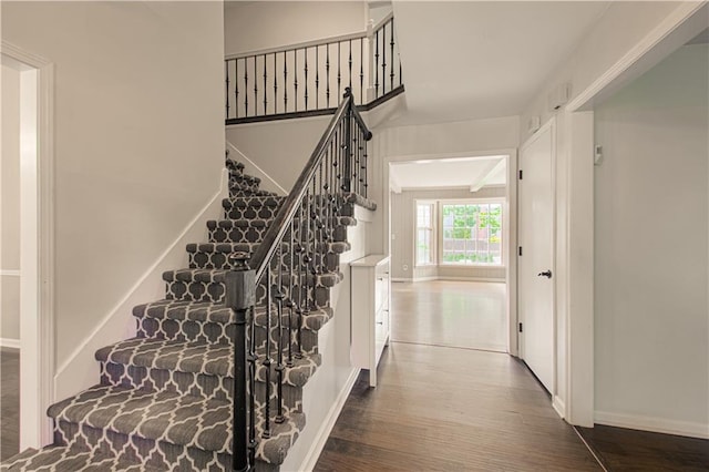 11643 Glen Arbor Ter, Kansas City, MO 64114 - stairway featuring wood finished floors and baseboards