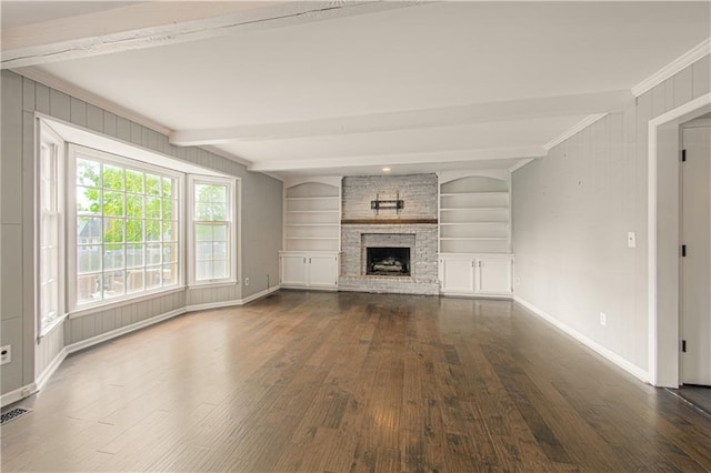 11643 Glen Arbor Ter, Kansas City, MO 64114 - unfurnished living room with dark wood-style flooring, ornamental molding, beam ceiling, a large fireplace, and baseboards