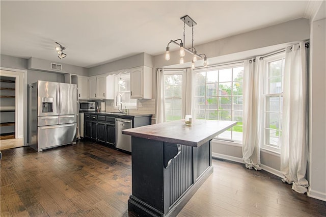 11643 Glen Arbor Ter, Kansas City, MO 64114 - kitchen featuring appliances with stainless steel finishes, a sink, dark wood-style floors, baseboards, and white cabinets