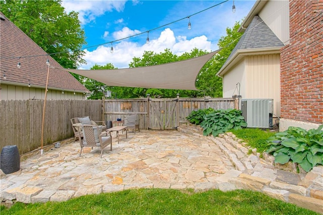 11643 Glen Arbor Ter, Kansas City, MO 64114 - view of patio featuring a fenced backyard and central AC