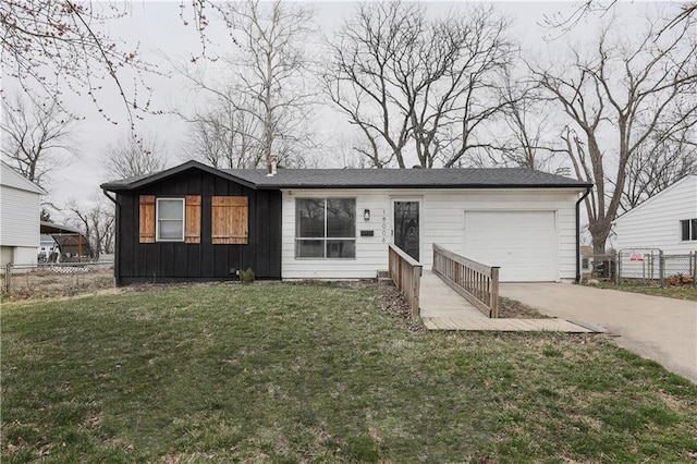 view of front facade with fence, driveway, a front lawn, a garage, and board and batten siding