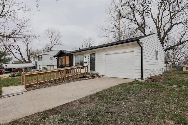 view of front of home featuring an attached garage, driveway, and fence