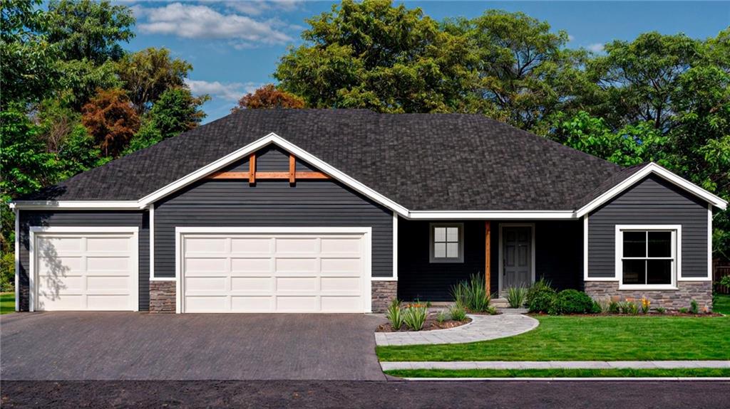 view of front of house featuring stone siding, driveway, an attached garage, and a front yard