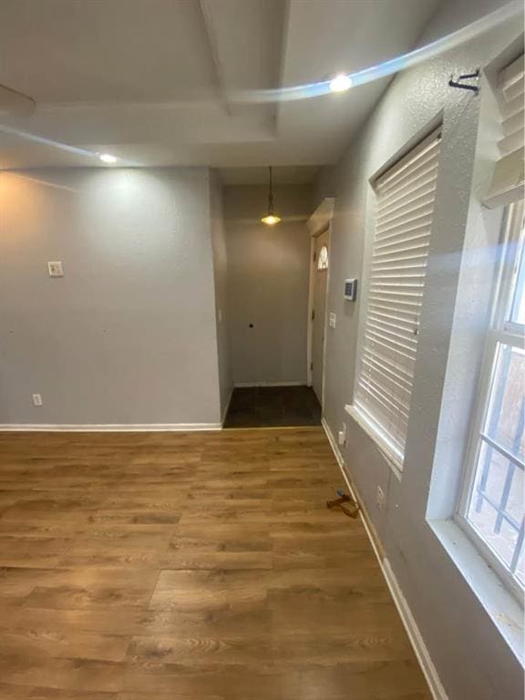 hall with wood finished floors and baseboards