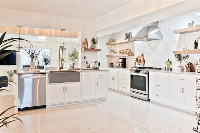 kitchen with backsplash, open shelves, wall chimney exhaust hood, and appliances with stainless steel finishes