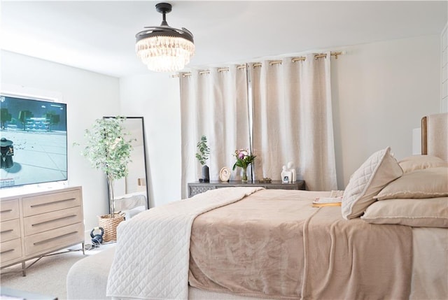 bedroom with carpet and an inviting chandelier