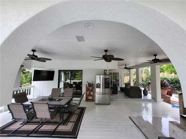 view of patio with outdoor dining space, outdoor lounge area, a deck, and a ceiling fan