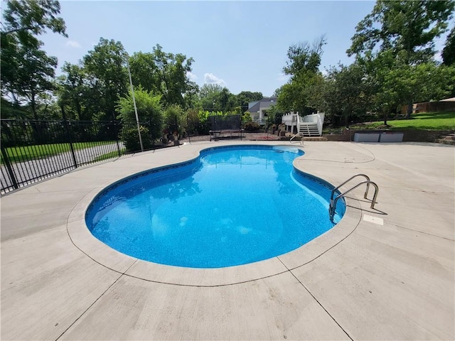 view of swimming pool featuring a patio area, fence, and a fenced in pool