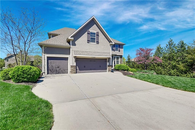 view of side of property with driveway, stone siding, stucco siding, an attached garage, and a yard