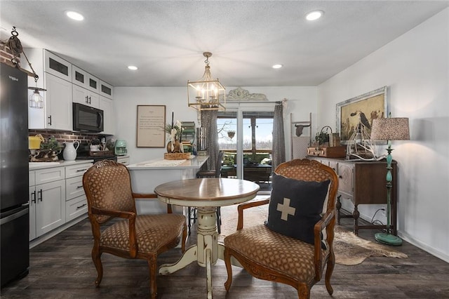 dining room with dark wood-style floors, baseboards, recessed lighting, a textured ceiling, and a chandelier