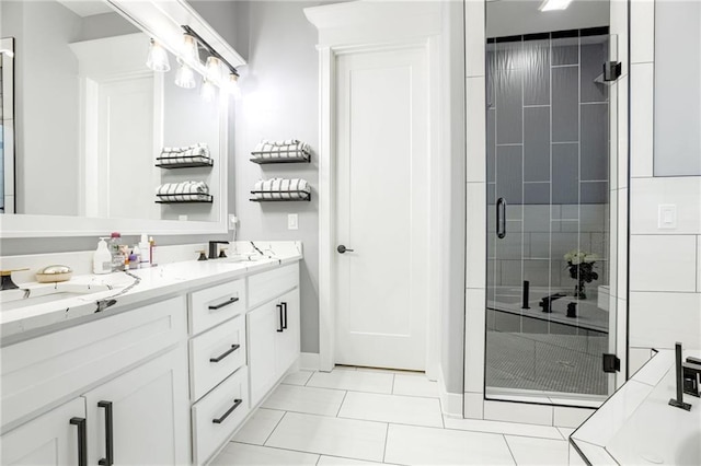 bathroom featuring a stall shower, double vanity, a sink, and tile patterned flooring