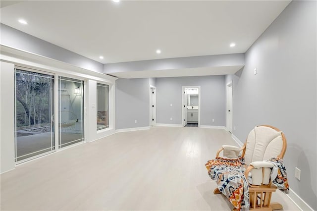 sitting room with light wood-type flooring, baseboards, and recessed lighting