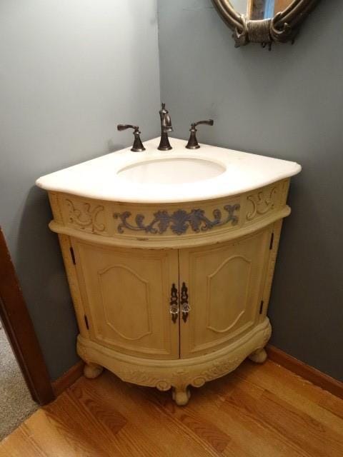 bathroom featuring vanity, wood finished floors, and baseboards