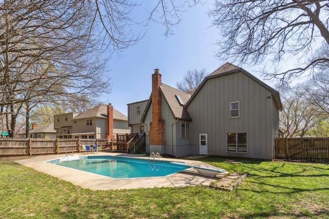 view of pool with a fenced in pool, a yard, a fenced backyard, and a wooden deck