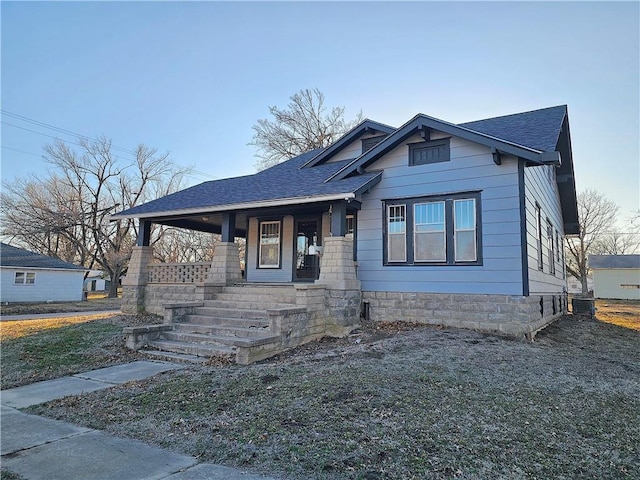 bungalow-style house featuring a porch and a shingled roof