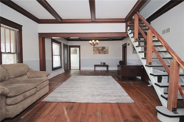 living room featuring stairs, a notable chandelier, visible vents, and a wealth of natural light