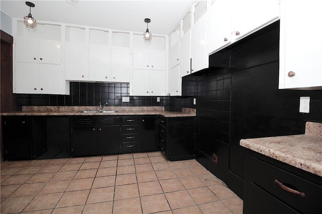 kitchen with decorative backsplash, a sink, light tile patterned floors, white cabinets, and dark cabinets