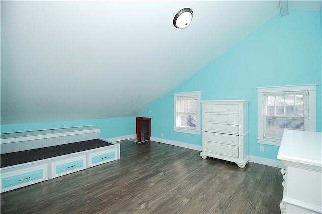 bonus room featuring dark wood-type flooring, baseboards, lofted ceiling, and a wealth of natural light