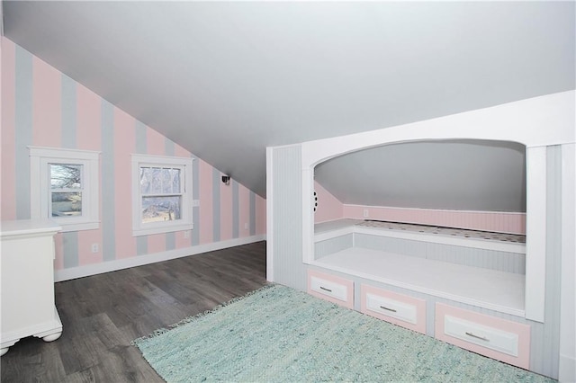 bonus room with baseboards, wood finished floors, vaulted ceiling, and wallpapered walls