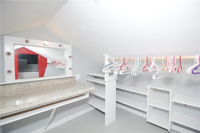 walk in closet with lofted ceiling