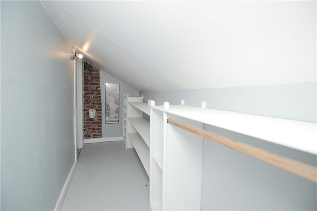 walk in closet featuring vaulted ceiling
