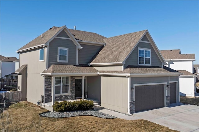 craftsman-style home featuring fence, covered porch, roof with shingles, concrete driveway, and a garage