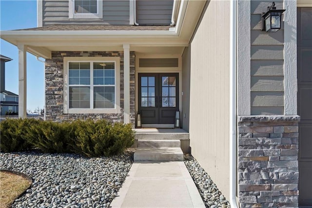 entrance to property featuring stone siding and french doors