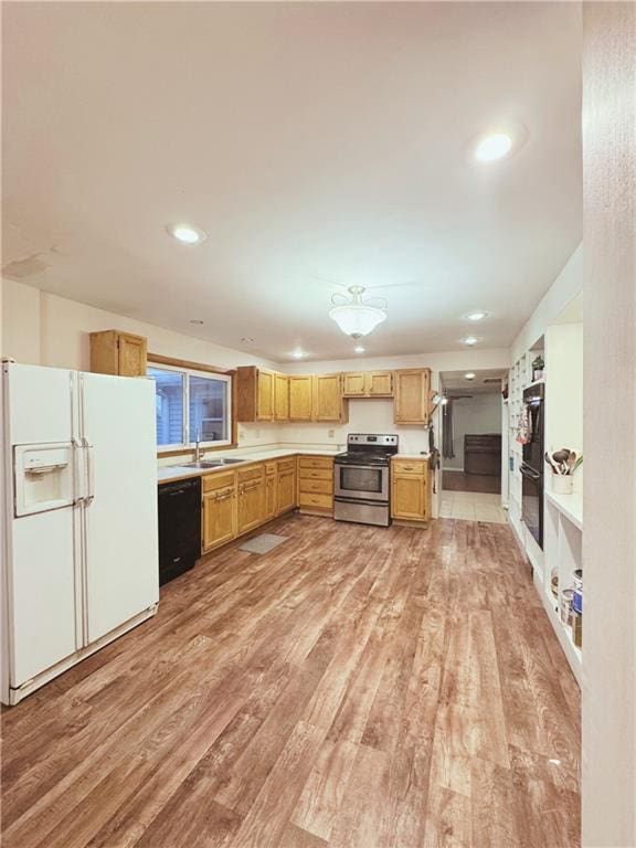 4900 E 219th St, Peculiar, MO 64078 - kitchen featuring black appliances, light wood-style floors, light countertops, and recessed lighting