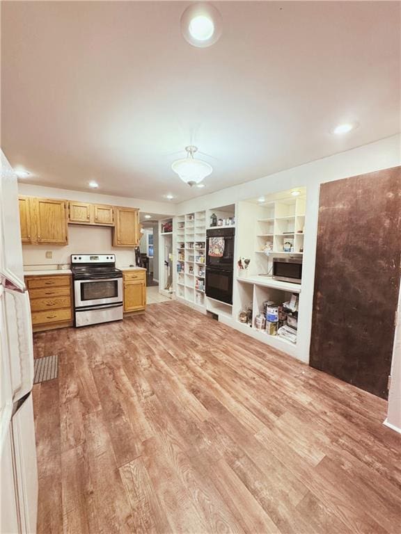 4900 E 219th St, Peculiar, MO 64078 - kitchen featuring appliances with stainless steel finishes, light wood finished floors, light countertops, light brown cabinetry, and built in shelves