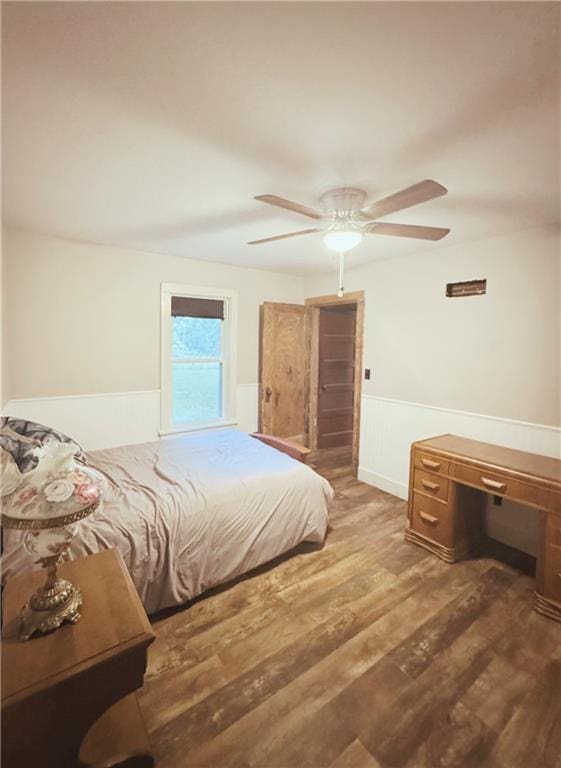 4900 E 219th St, Peculiar, MO 64078 - bedroom with wood finished floors, a wainscoted wall, and ceiling fan