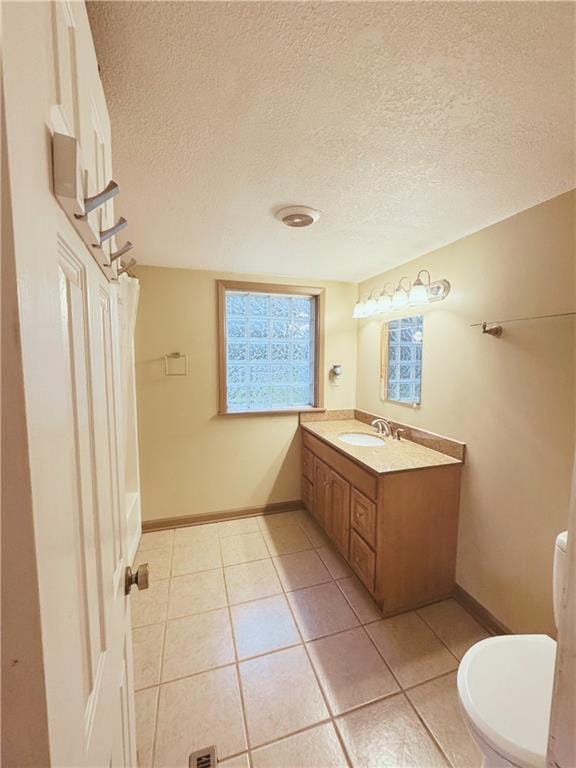 4900 E 219th St, Peculiar, MO 64078 - bathroom with vanity, tile patterned floors, and a textured ceiling