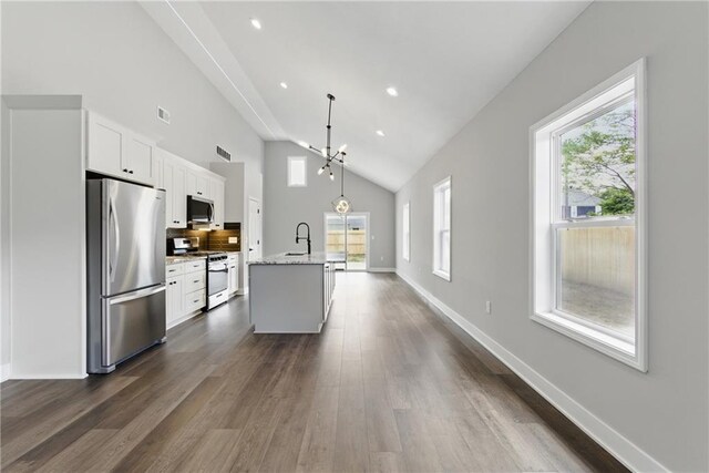 1219 S 36th St, Kansas City, KS 66106 - kitchen with stainless steel appliances, white cabinets, and plenty of natural light