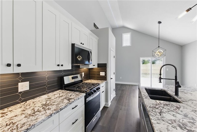 1219 S 36th St, Kansas City, KS 66106 - kitchen featuring visible vents, a sink, backsplash, appliances with stainless steel finishes, and dark wood-style floors