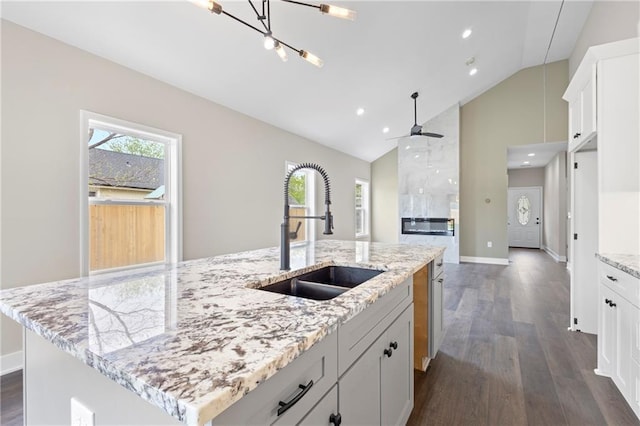 1219 S 36th St, Kansas City, KS 66106 - kitchen with white cabinets, plenty of natural light, dark wood-style floors, and a sink