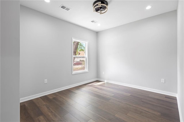 1219 S 36th St, Kansas City, KS 66106 - spare room featuring visible vents, baseboards, dark wood-type flooring, and recessed lighting