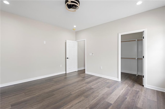 1219 S 36th St, Kansas City, KS 66106 - unfurnished bedroom featuring recessed lighting, baseboards, a spacious closet, and dark wood-style floors