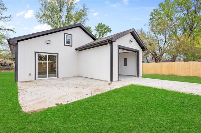 1219 S 36th St, Kansas City, KS 66106 - rear view of property featuring a lawn, a patio area, and fence