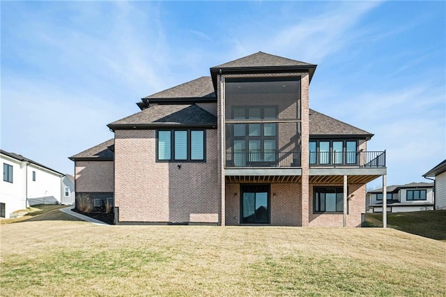 2171 NW Palisades Dr, Riverside, MO 64150 - rear view of house featuring a lawn, brick siding, and roof with shingles
