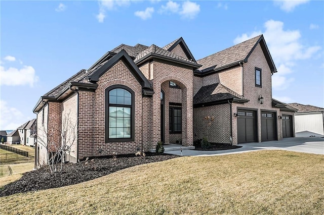 2171 NW Palisades Dr, Riverside, MO 64150 - french provincial home featuring brick siding, driveway, an attached garage, and a front yard