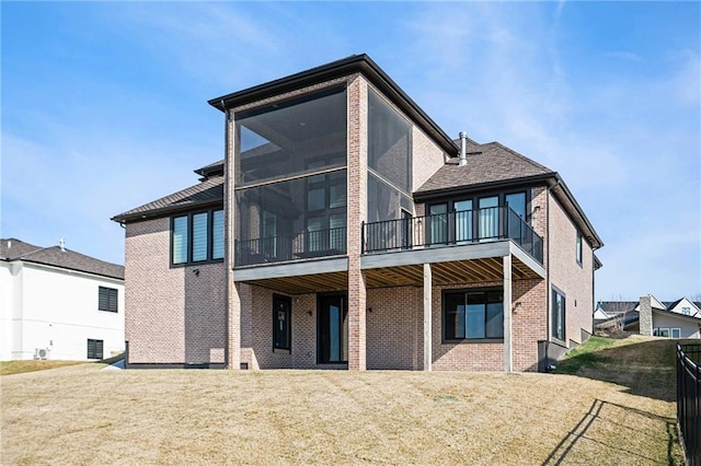 2171 NW Palisades Dr, Riverside, MO 64150 - rear view of house featuring brick siding and a sunroom