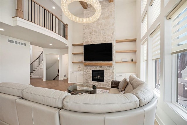 2171 NW Palisades Dr, Riverside, MO 64150 - living area with a high ceiling, baseboards, a fireplace, stairway, and wood finished floors