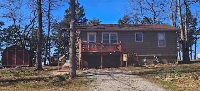 view of front of property with a shed, a wooden deck, and an outdoor structure
